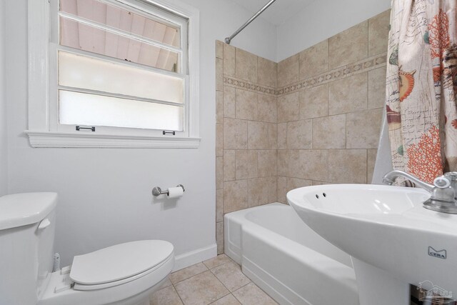 full bathroom featuring toilet, shower / tub combo, a sink, baseboards, and tile patterned floors