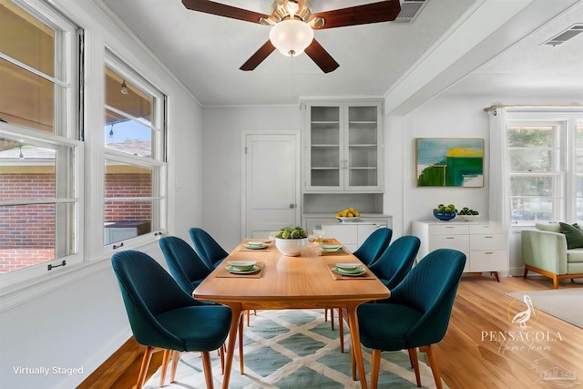 dining room featuring plenty of natural light, visible vents, and light wood-style floors