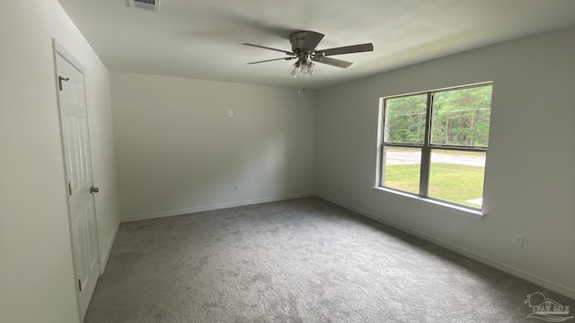 empty room featuring baseboards, a ceiling fan, carpet, and visible vents