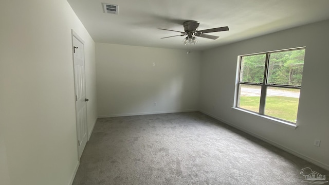 unfurnished room with visible vents, carpet, ceiling fan, and baseboards