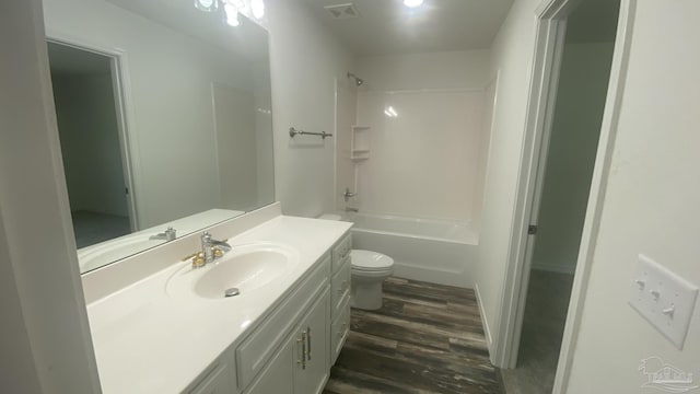 bathroom featuring vanity, toilet, bathing tub / shower combination, wood finished floors, and visible vents