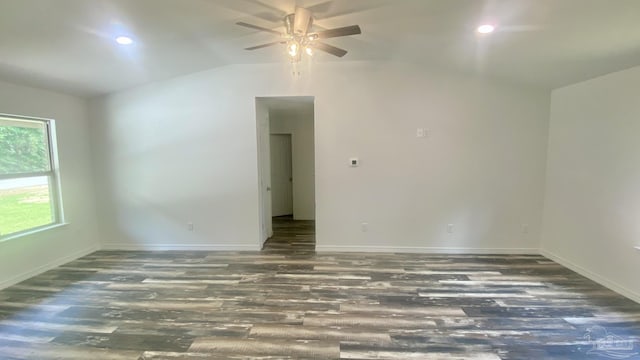 unfurnished room featuring baseboards, ceiling fan, vaulted ceiling, and wood finished floors
