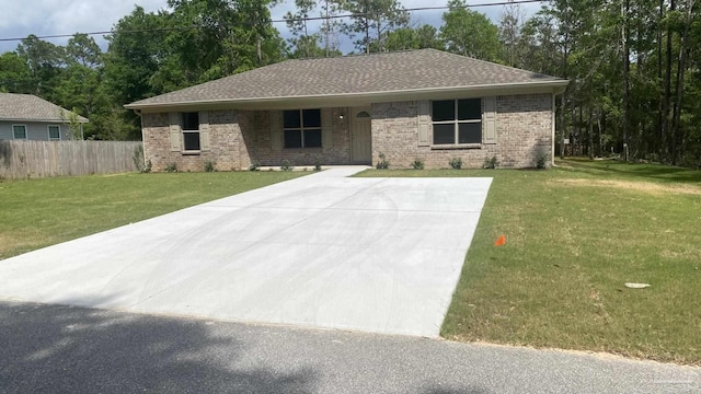 single story home featuring brick siding, fence, and a front yard