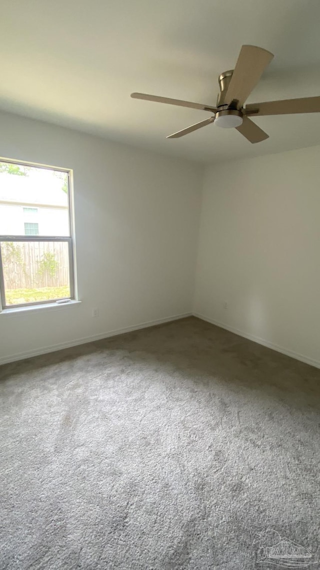 unfurnished room featuring baseboards, carpet, and ceiling fan
