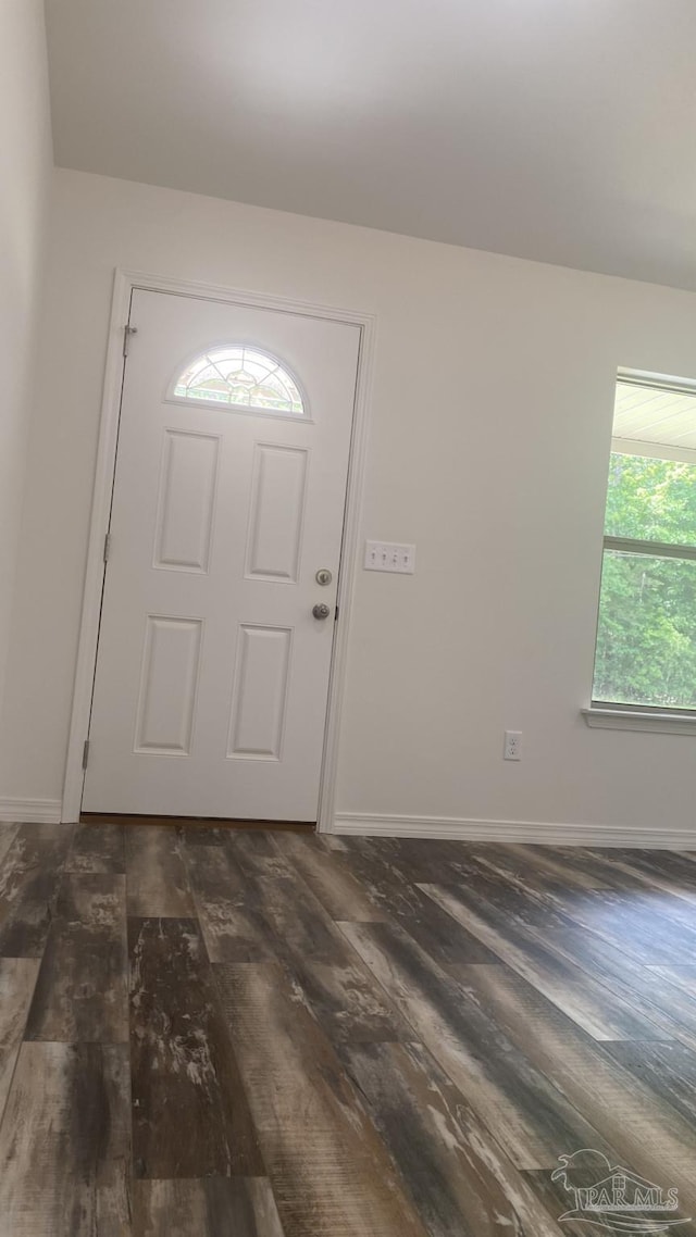 entrance foyer featuring baseboards and dark wood-style flooring