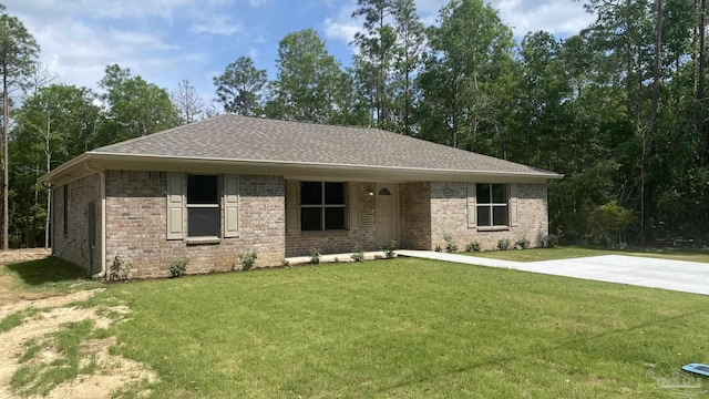 ranch-style house with brick siding, a shingled roof, and a front yard