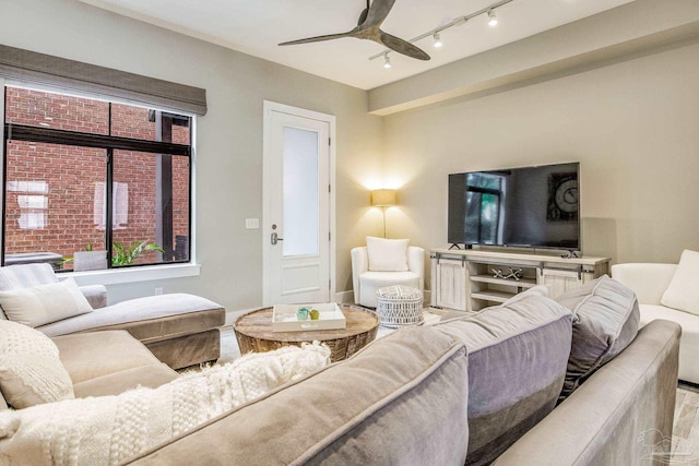 living room featuring baseboards and ceiling fan