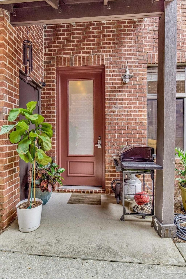 property entrance with brick siding