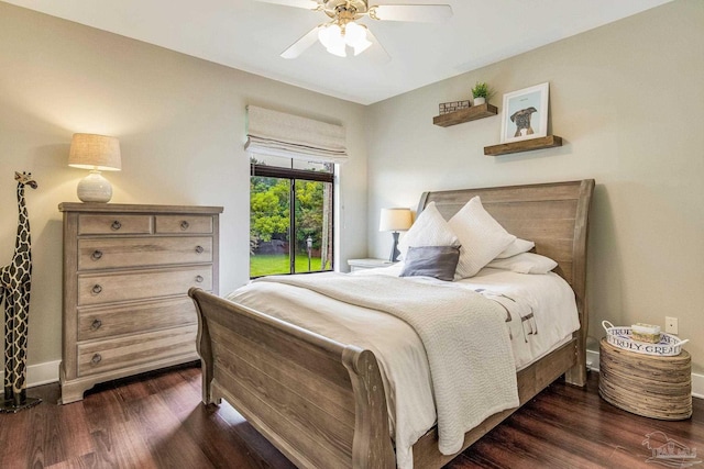 bedroom with a ceiling fan, dark wood-style floors, and baseboards