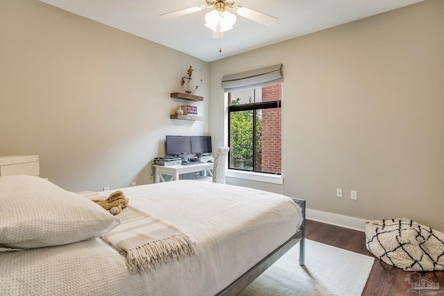 bedroom featuring wood finished floors, baseboards, and ceiling fan