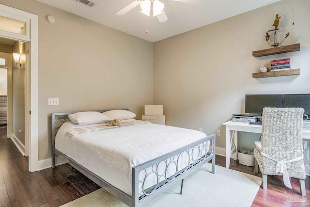 bedroom with visible vents, ceiling fan, baseboards, and wood finished floors