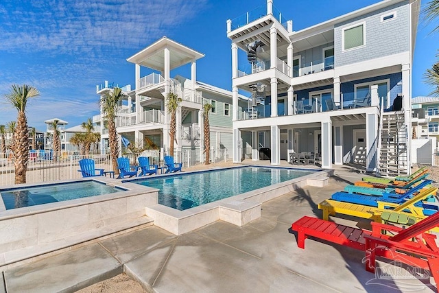 view of swimming pool with a patio area and an in ground hot tub