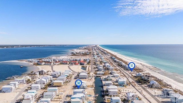 birds eye view of property with a water view and a view of the beach