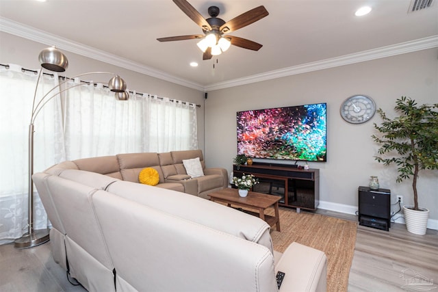 living room featuring ceiling fan, ornamental molding, and wood-type flooring