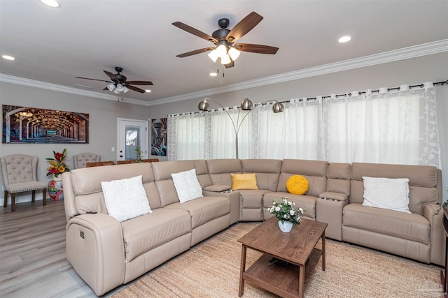 living room featuring ornamental molding, ceiling fan, and light hardwood / wood-style flooring