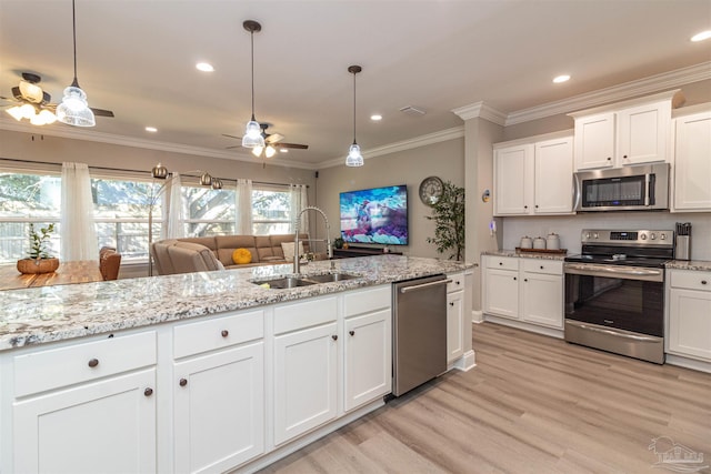 kitchen with pendant lighting, white cabinetry, appliances with stainless steel finishes, ceiling fan, and sink