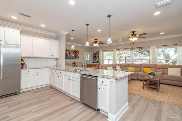 kitchen featuring kitchen peninsula, stainless steel appliances, ceiling fan, and white cabinetry