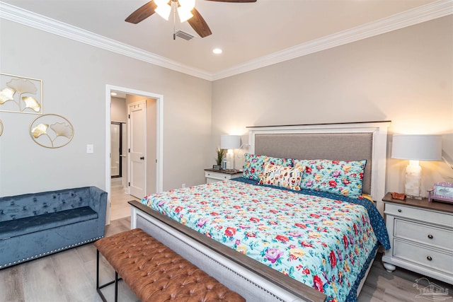 bedroom featuring ceiling fan, hardwood / wood-style floors, and crown molding