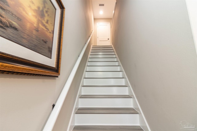 stairway featuring hardwood / wood-style floors