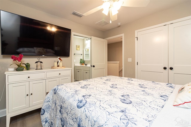 bedroom featuring ensuite bath, ceiling fan, and dark hardwood / wood-style floors