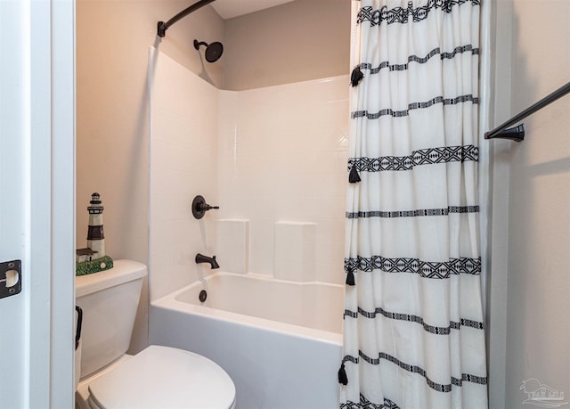 bathroom with toilet and shower / bath combo with shower curtain