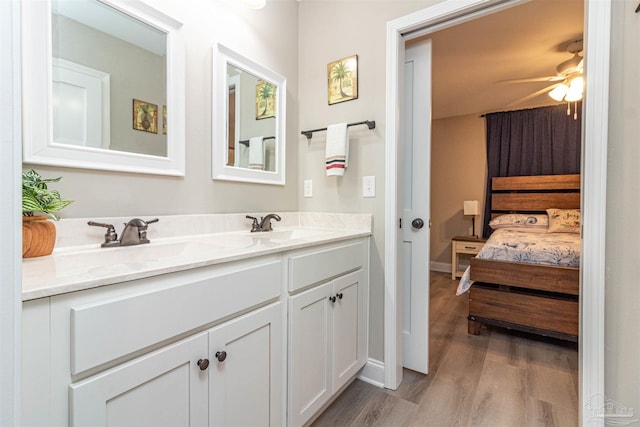 bathroom with ceiling fan, wood-type flooring, and vanity