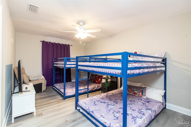 bedroom with ceiling fan and hardwood / wood-style flooring