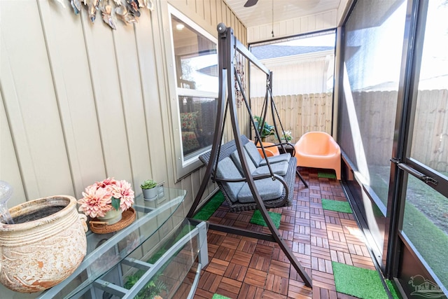 sunroom / solarium featuring ceiling fan and plenty of natural light