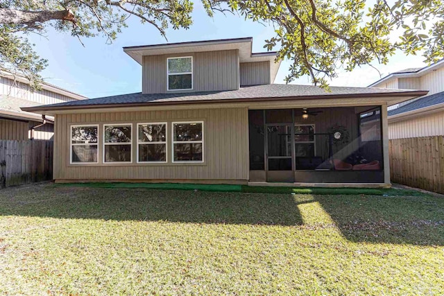 back of property featuring a yard and a sunroom