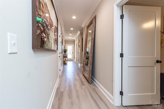 hallway with light wood-type flooring and crown molding