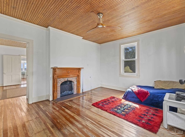 interior space featuring hardwood / wood-style flooring, ceiling fan, crown molding, and wood ceiling