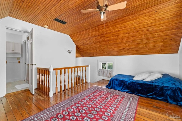bedroom with hardwood / wood-style floors, visible vents, lofted ceiling, and wood ceiling