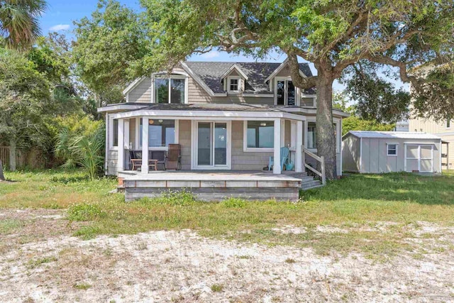 view of front of property featuring an outdoor structure, a shed, and a front yard