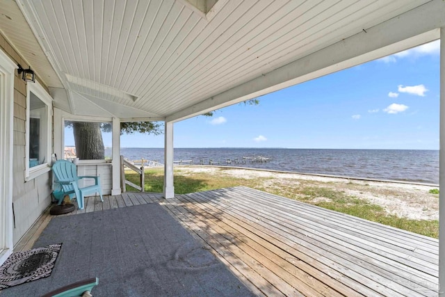 deck featuring a beach view and a water view