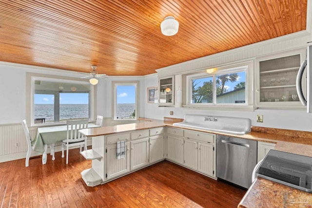 kitchen with a ceiling fan, a peninsula, appliances with stainless steel finishes, and wood ceiling