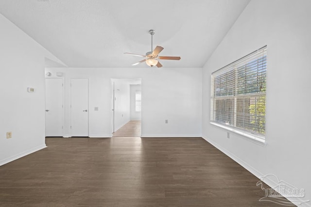 unfurnished living room featuring dark hardwood / wood-style floors, vaulted ceiling, and ceiling fan