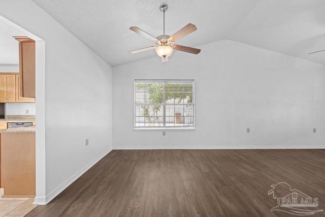 unfurnished living room with dark hardwood / wood-style flooring, ceiling fan, and lofted ceiling