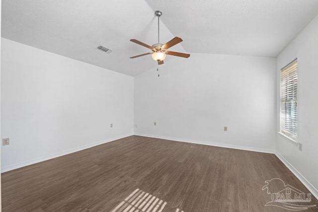 spare room with ceiling fan, dark hardwood / wood-style flooring, and vaulted ceiling