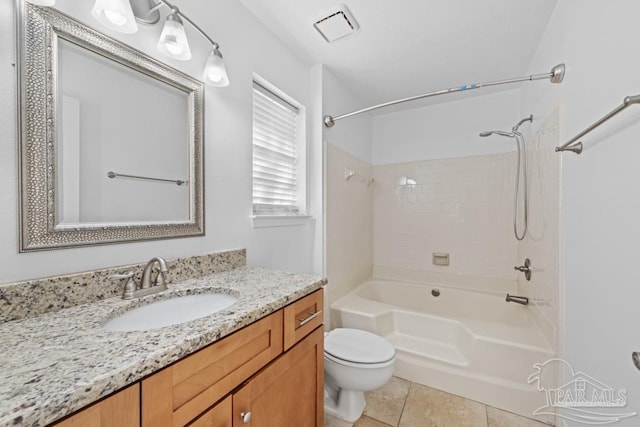 full bathroom with vanity, tiled shower / bath combo, tile patterned floors, and toilet