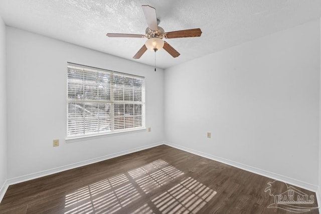 empty room featuring a textured ceiling, dark hardwood / wood-style floors, and ceiling fan