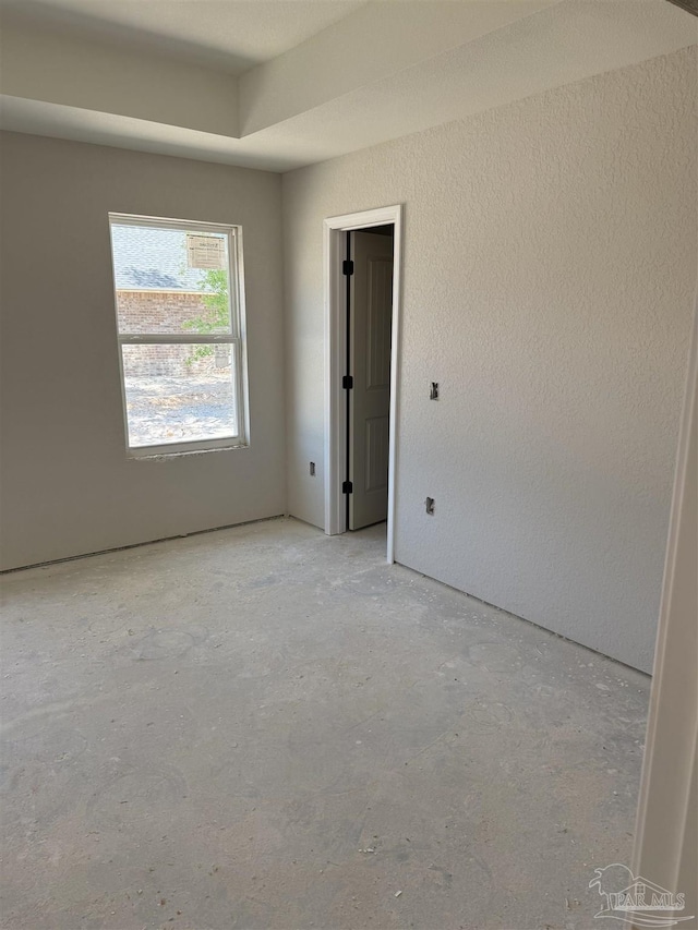 spare room featuring concrete flooring