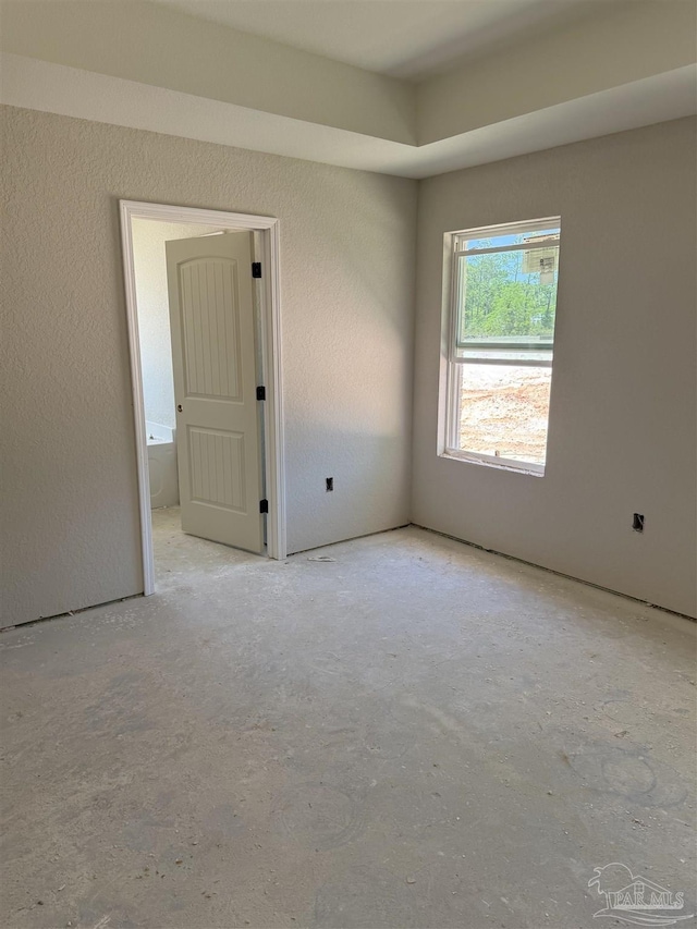 unfurnished room with concrete floors