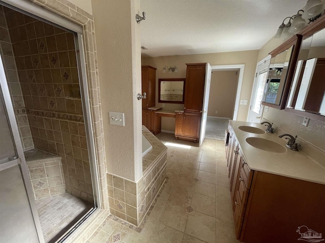 bathroom featuring vanity, a textured ceiling, and plus walk in shower