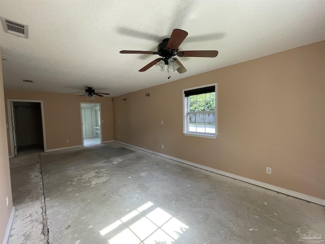 unfurnished room with a textured ceiling