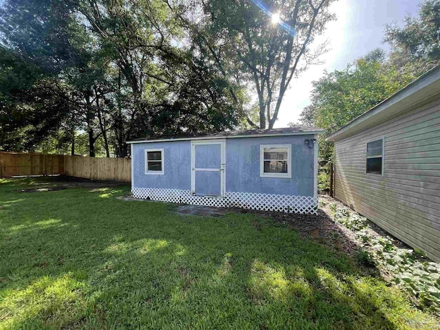 view of outbuilding featuring a lawn