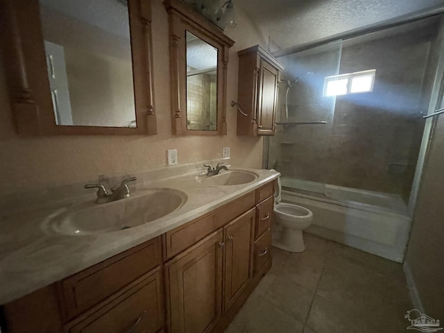 full bathroom featuring tiled shower / bath combo, vanity, toilet, tile patterned floors, and a textured ceiling