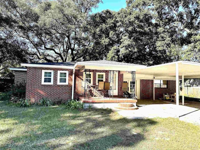 view of front of property with a front yard and a carport