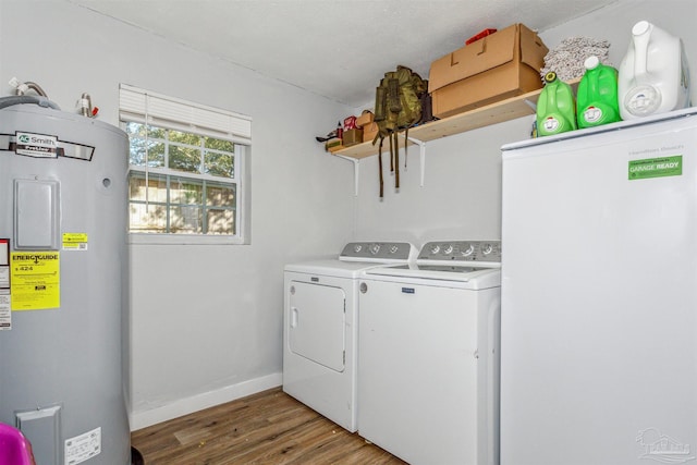 laundry room with water heater, hardwood / wood-style floors, a textured ceiling, and independent washer and dryer