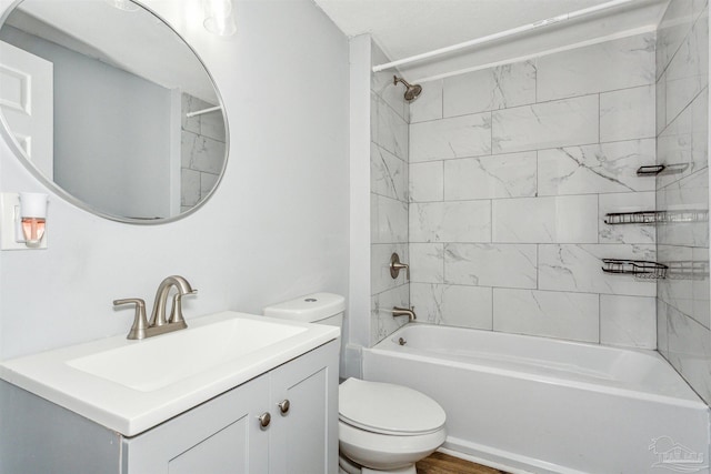 full bathroom featuring toilet, vanity, wood-type flooring, and tiled shower / bath