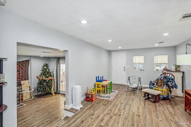 game room with light hardwood / wood-style floors